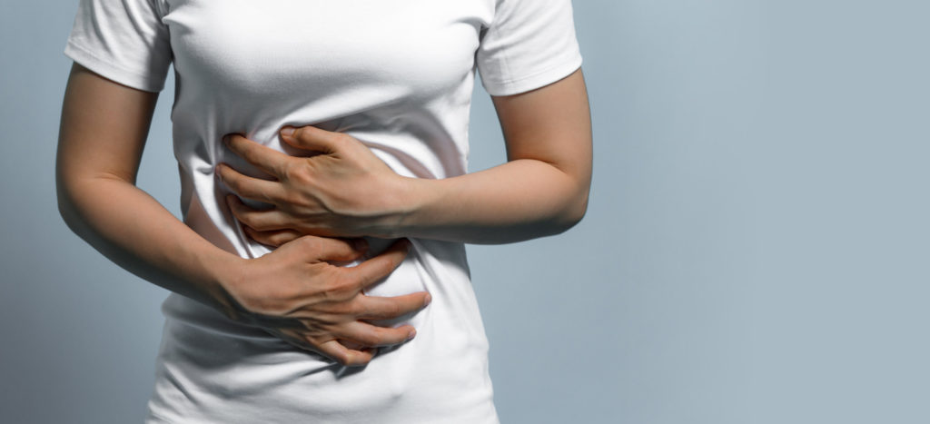 man with parasite holding stomach