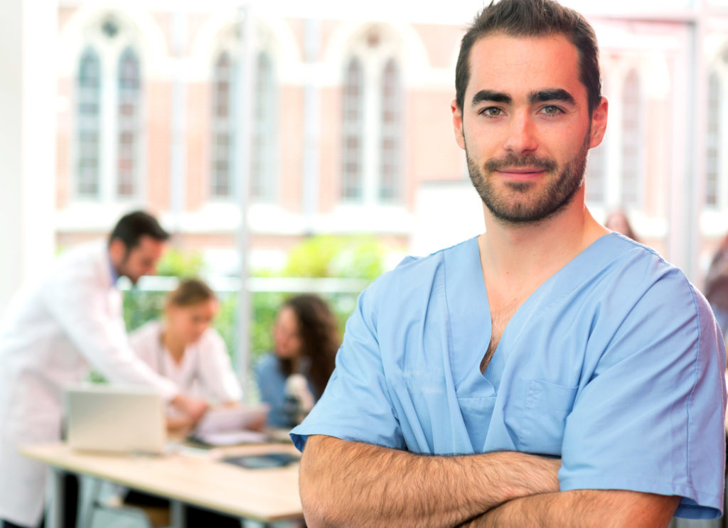 male nurse standing a facility