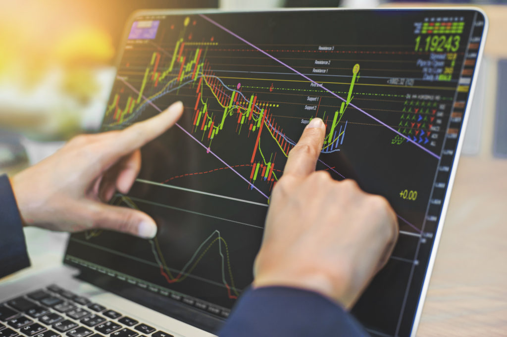 man trading stocks on his computer